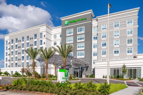 Palm tree-lined exterior of Holiday Inn & Suites Orlando I-Drive.