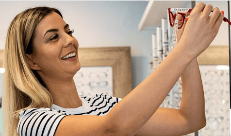 woman choosing a pair of glasses