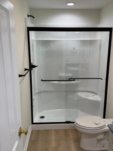 Modern basement bathroom with tiled shower and floating vanity