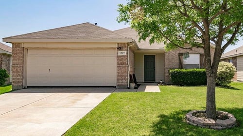 large front load garage attached to ranch