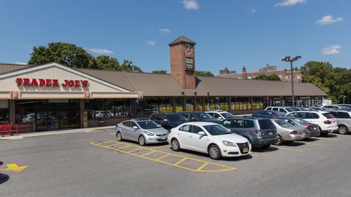 full parking lot in at entrance of Trader Joe's at Village Square Shopping Center