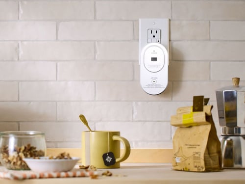 A plugged-in co alarm in a kitchen.