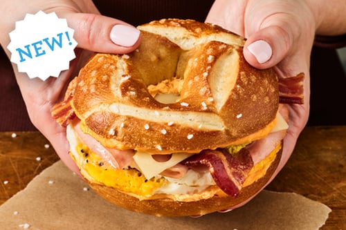 Einstein bros bagels Oktoberfest Breakfast Egg Sandwich with beer cheese shmear, mustard, ham, bacon, Swiss cheese and cage-free eggs