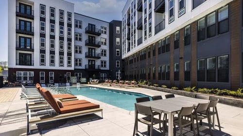 Resort style pool with outdoor lounge chairs.