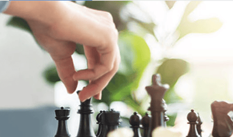 a hand moving chess pieces