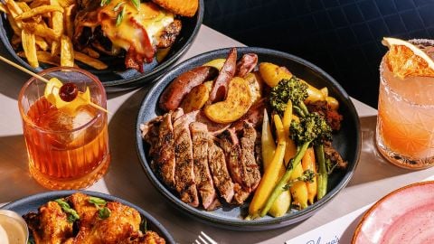 Dishes and cocktails on table at Paloma's at Lela