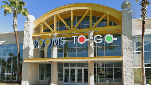 Storefront of Rooms To Go, furniture store in Melbourne, FL.