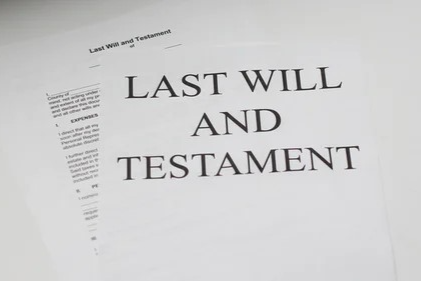 Image of papers with the text Last Will And Testamant written on the cover page.