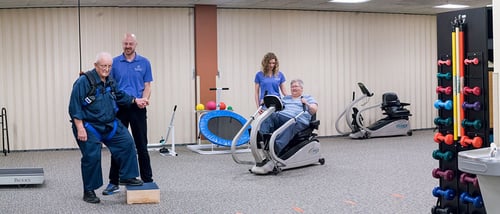 Therapists working with residents in the Ascend Rehabilitation therapy gym