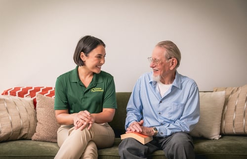 Home Instead Caregiver and Client Smiling at Each Other