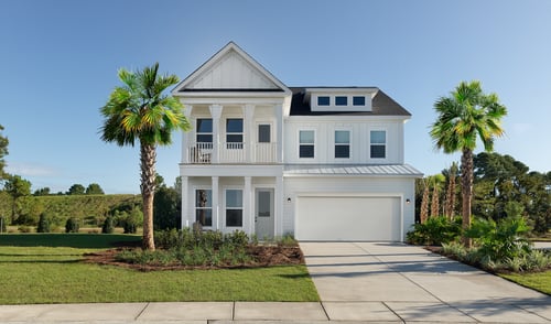 White Charleston-style home with 2-story porches and palm trees