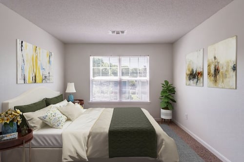Green-themed bedroom with indoor plant