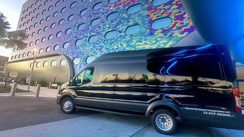 Black shuttle van parked in front of resort