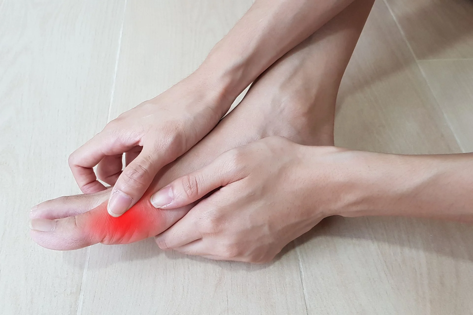 person rubbing their foot in discomfort with bunion