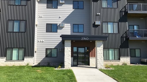 Main entrance of the building with green space in front of it, Mezzo Apartments, Fargo, ND