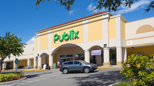 Blue SUV passes entrance of Publix at Venice Shopping Center