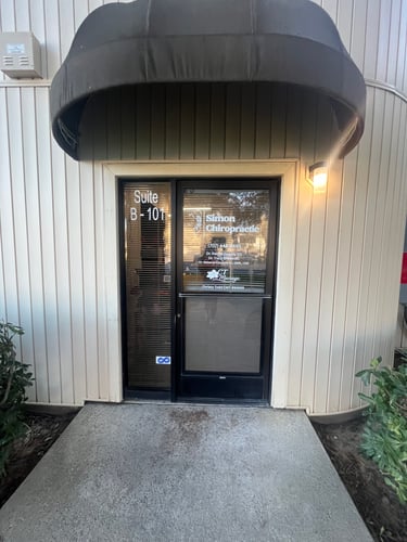 The exterior business signage of Simon Chiropractic.