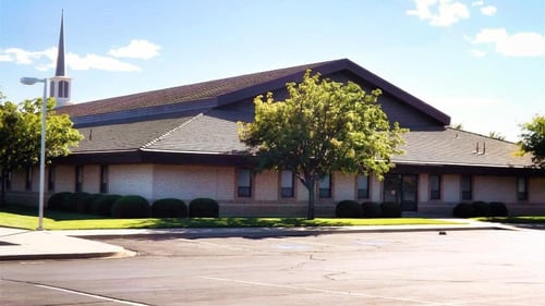 Light tan brick building with brown roof