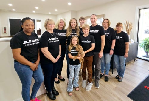 Agent Shawn and his team all in black t shirts and jeans in an office setting