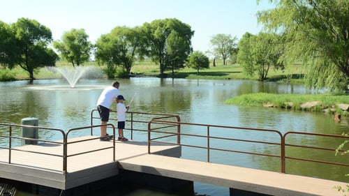 Father and son fishing from a dock