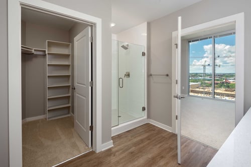 Bathroom with shower and walk-in closets