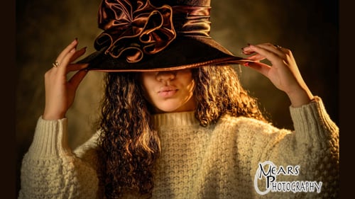 Girl posing with a large hat