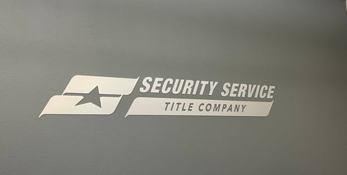 Security Service Title Company logo located on wall just outside the office.
