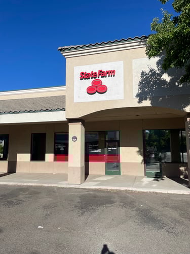 Tan building with red State Farm sign