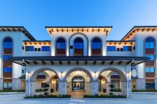 Front of Hotel Indigo Spring-Woodlands Area exterior at dusk