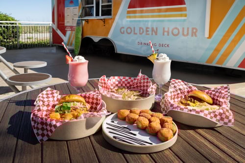 The Golden Hour container bar with a display of food and drinks
