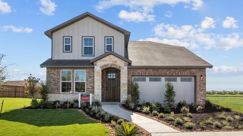 two-story new home with brick and white exterior