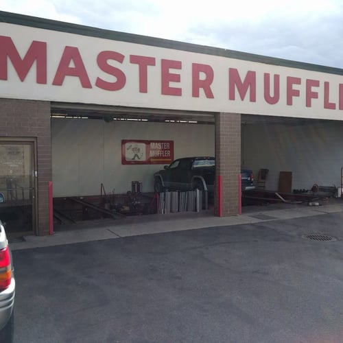 Mechanic repairing a vehicle in an auto repair shop.