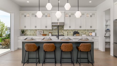 Chef inspired kitchen with gas range, large center island, and abundant cabinet space