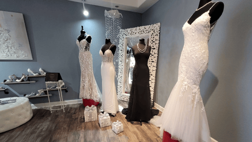 four wedding dresses on mannequins at BridalXoXo