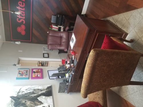 Gray walls with brown desk and chair