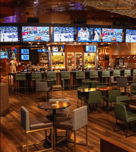 Interior of Caesars Sportsbook at Caesars Windsor with large game screens and seating on Riverside Drive East in Windsor, Ontario