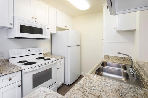 Kitchen with White Cabinets at Northridge Gardens Apartments in Northridge, Los Angeles, CA