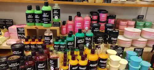 Large colourful display of packaged and unpackaged shower products.
