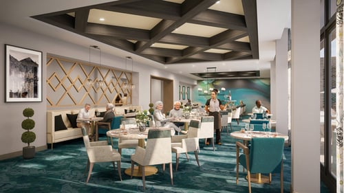 Dining room with green carpet and tan furniture with a few people at the tables