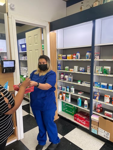 A pharmacist giving a patient her medications