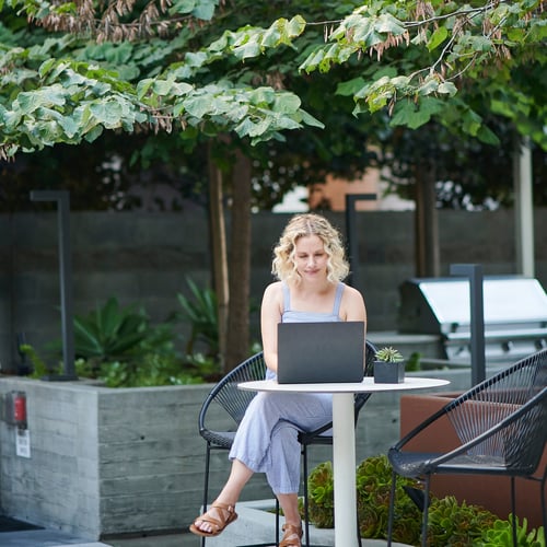 Woman using laptop in a public area