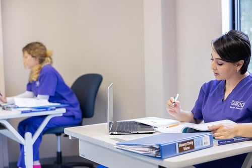Two Centura College Female students, one Hispanic, one White studying to become medical assistants.