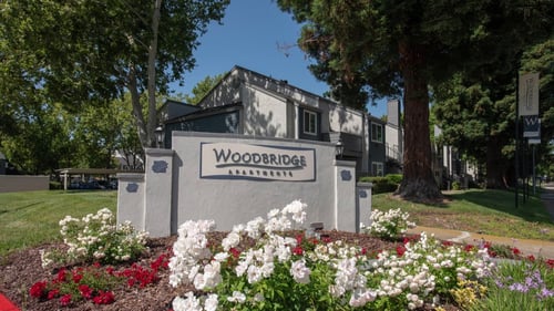 Property sign at Woodbridge Apartments in Sacramento, CA 95833