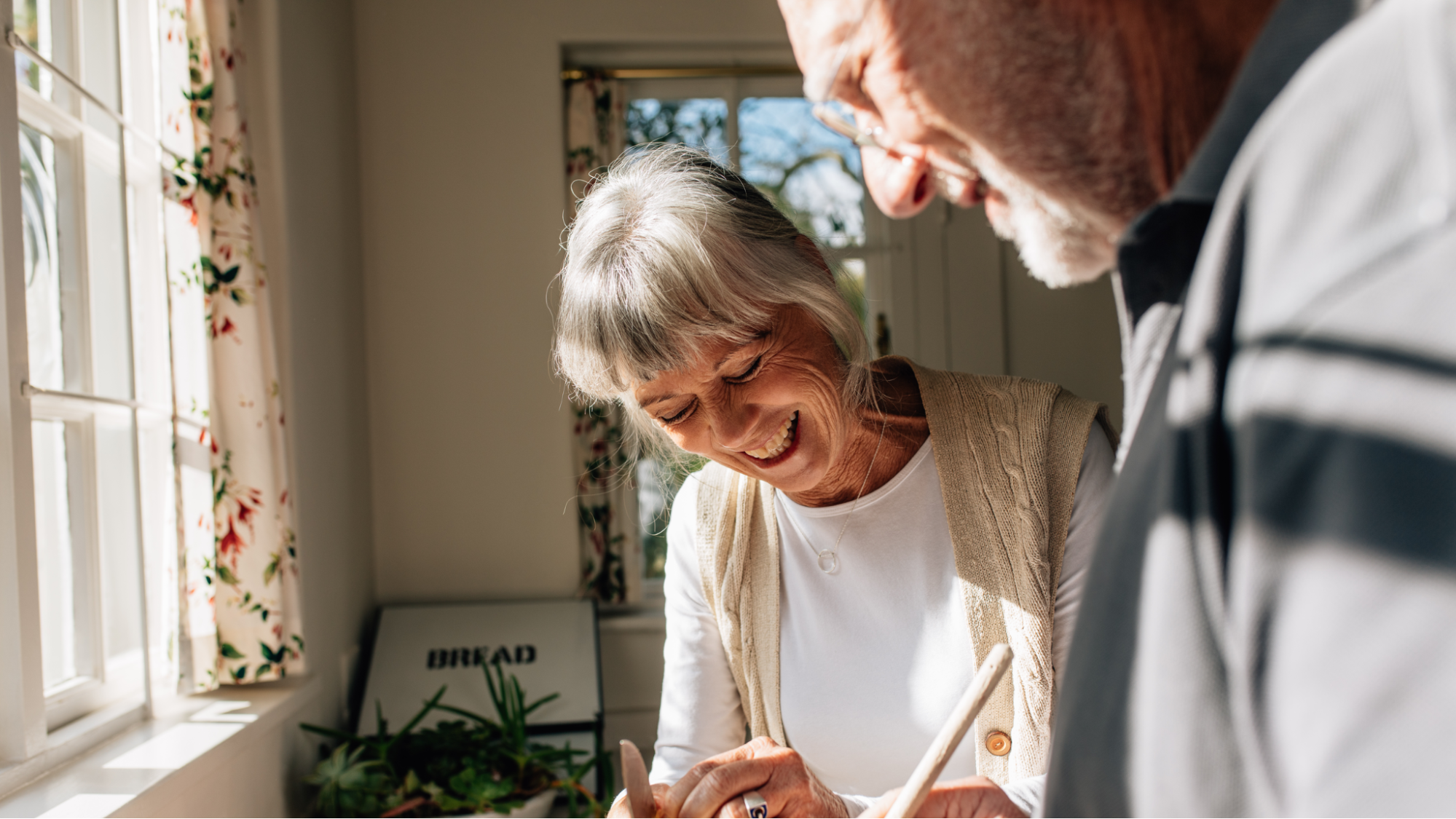 elderly couple happily cooking together