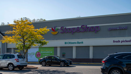 Yellow tree on the left side of the Stop & Shop facade