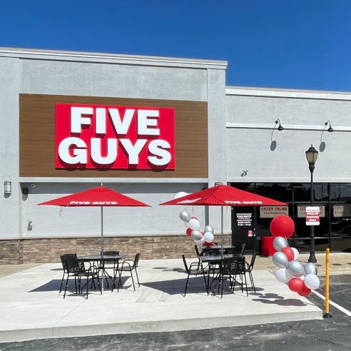 Exterior photograph of the entrance to the Five Guys restaurant at 309 Huffman Mill Road in Burlington North Carolina.