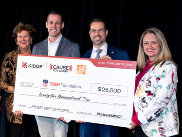 Fire Department New York receiving a donation check from Kidde, iHeart Media and the Home Depot.