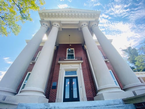 Brown brick building with tan pillars