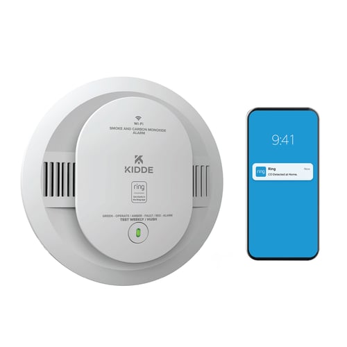 A smart phone next to a Kidde combination smoke and co alarm, with a notification from the Ring app.