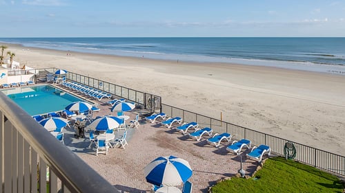 Balcony view of the pool and beach at Dolphin Beach Club.